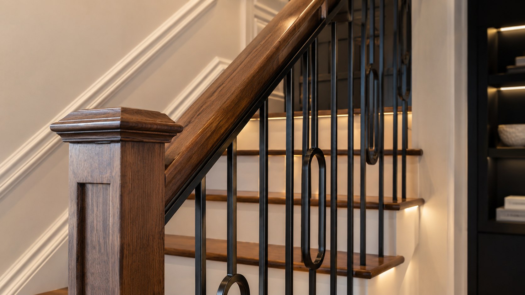 Design inspiration: wood staircase with black metal balusters and warm lighting